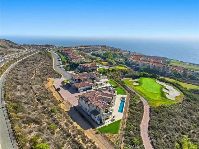 a living room with furniture a fireplace and a chandelier