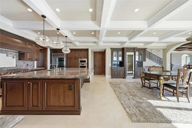 a view of a dining room with furniture wooden floor and a chandelier