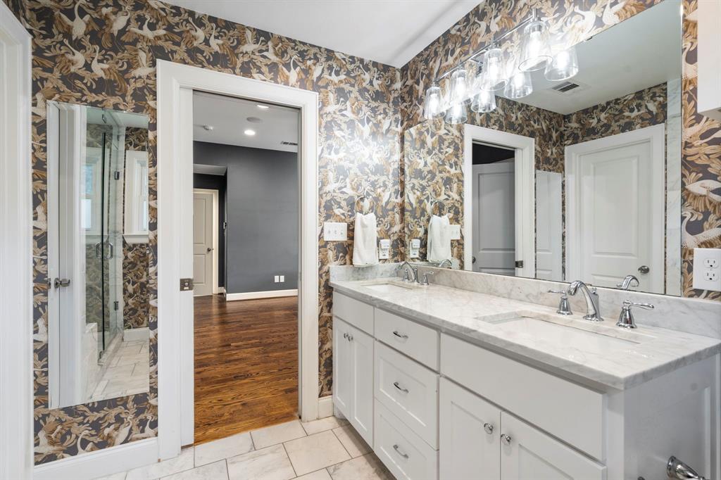 6446 Runnemede Lane Dallas, TX 75214 - Photo 11 of 23 a bathroom with a double vanity sink and a mirror