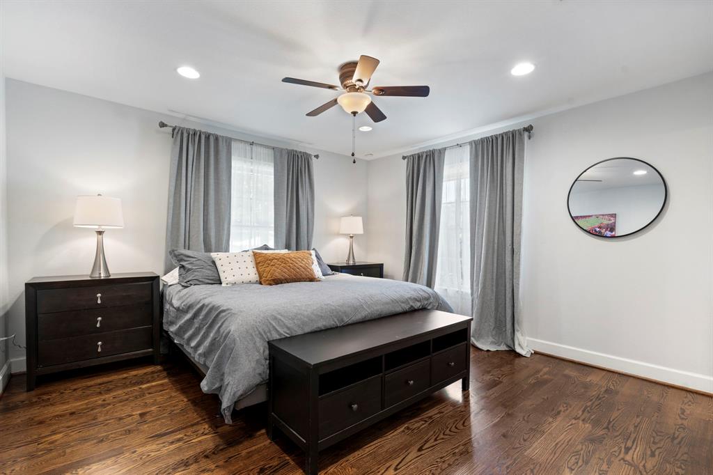 6446 Runnemede Lane Dallas, TX 75214 - Photo 13 of 23 a bedroom with a bed and a chandelier