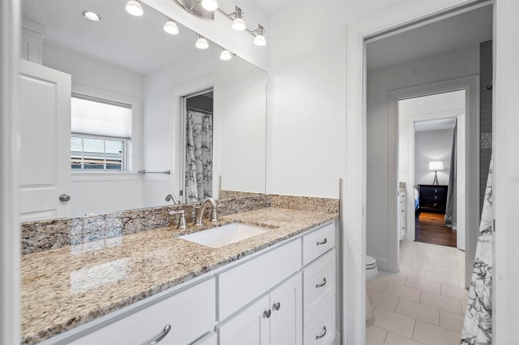 6446 Runnemede Lane Dallas, TX 75214 - Photo 14 of 23 a bathroom with a granite countertop sink and a mirror