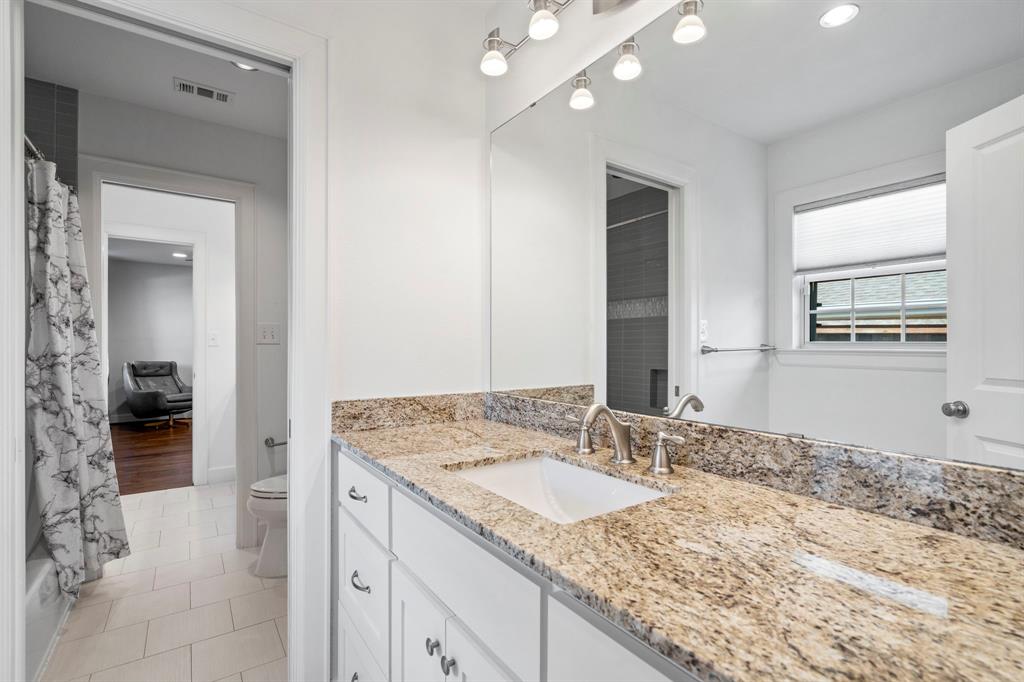 6446 Runnemede Lane Dallas, TX 75214 - Photo 15 of 23 a bathroom with a granite countertop sink and a mirror
