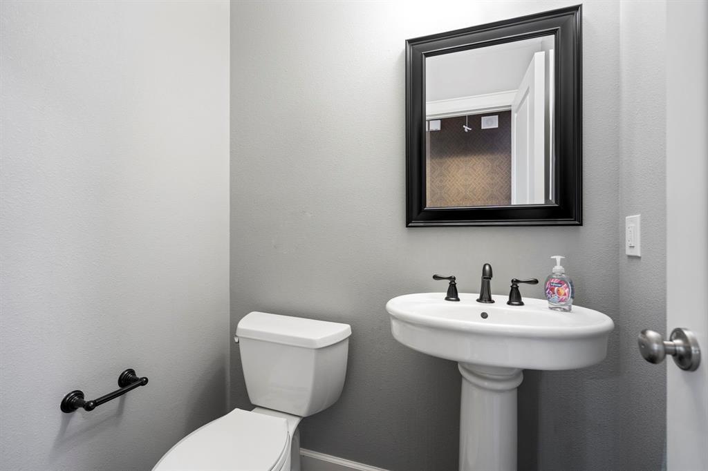 6446 Runnemede Lane Dallas, TX 75214 - Photo 19 of 23 a bathroom with a toilet sink and mirror