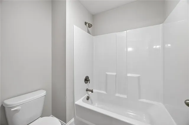 a bathroom with a bathtub and a toilet
