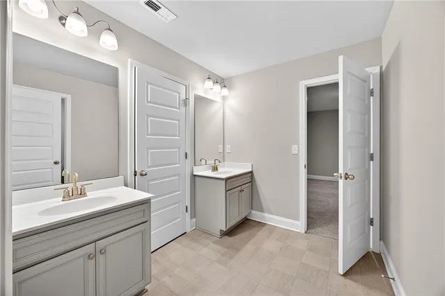 a bathroom with a sink vanity and a mirror