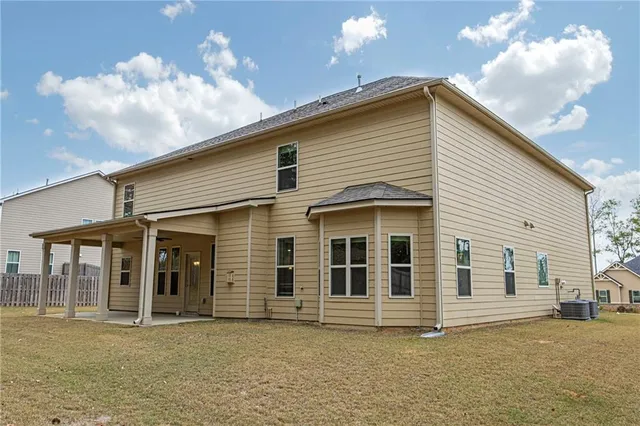 a view of a house with a wooden deck