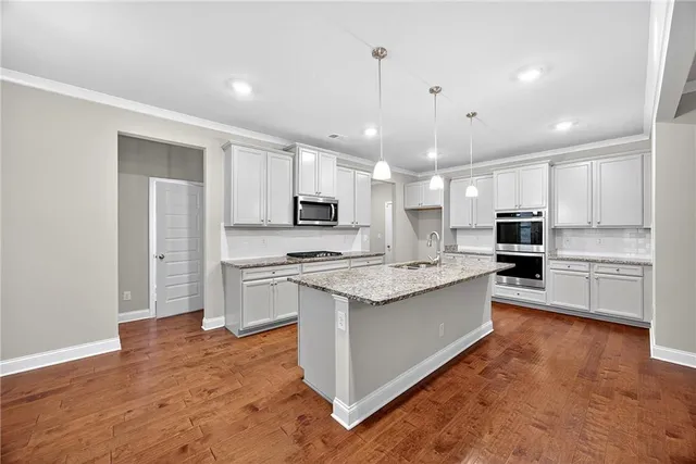 a large kitchen with cabinets and stainless steel appliances