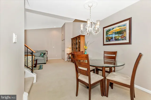 a view of a dining room with furniture and chandelier
