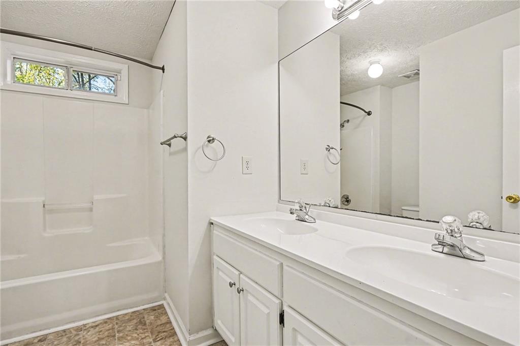 4083 Country Lane Gainesville, GA 30507 - Photo 15 of 18 a bathroom with a tub sink and mirror