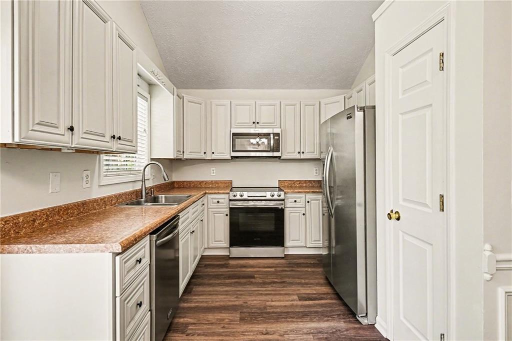 4083 Country Lane Gainesville, GA 30507 - Photo 3 of 18 a kitchen with stainless steel appliances granite countertop a stove and a refrigerator