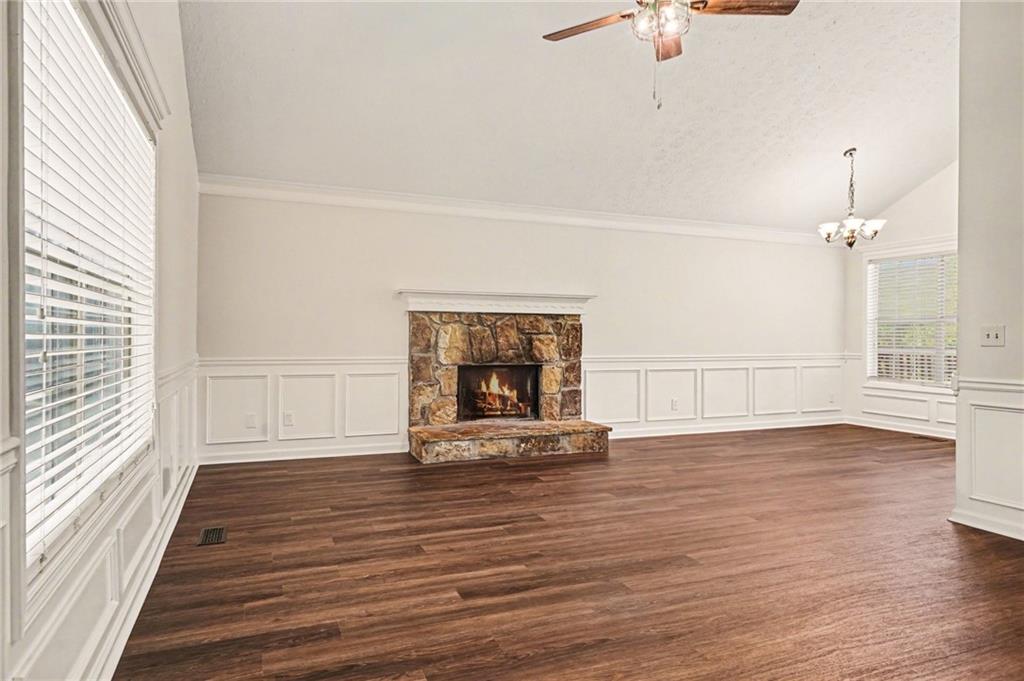 4083 Country Lane Gainesville, GA 30507 - Photo 6 of 18 a view of an empty room with wooden floor fireplace and a window