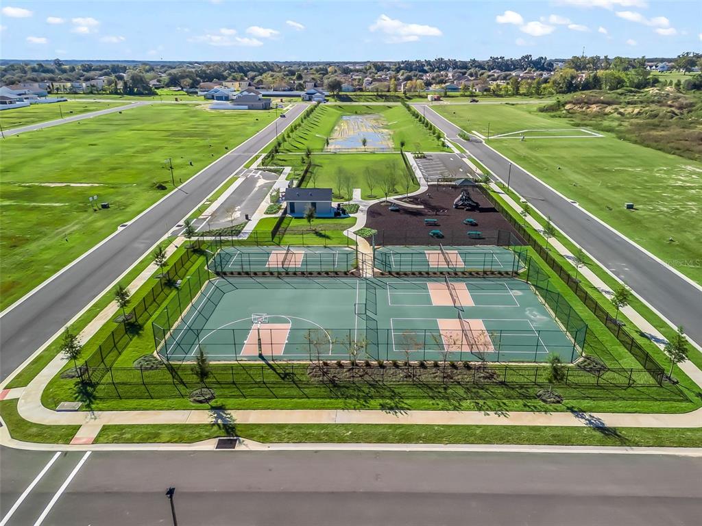 4 Northeast 125th Loop Oxford, FL 34484 - Photo 1 of 13 a view of swimming pool with a garden and outdoor seating