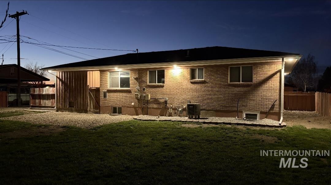 905 15th Drive Rupert, ID 83350 - Photo 20 of 20 Brick exterior featuring multiple windows and a dark shingled roof