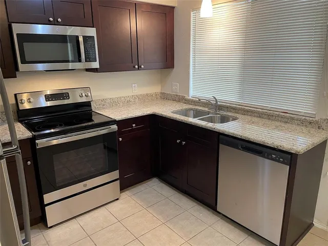 a kitchen with a sink and a microwave