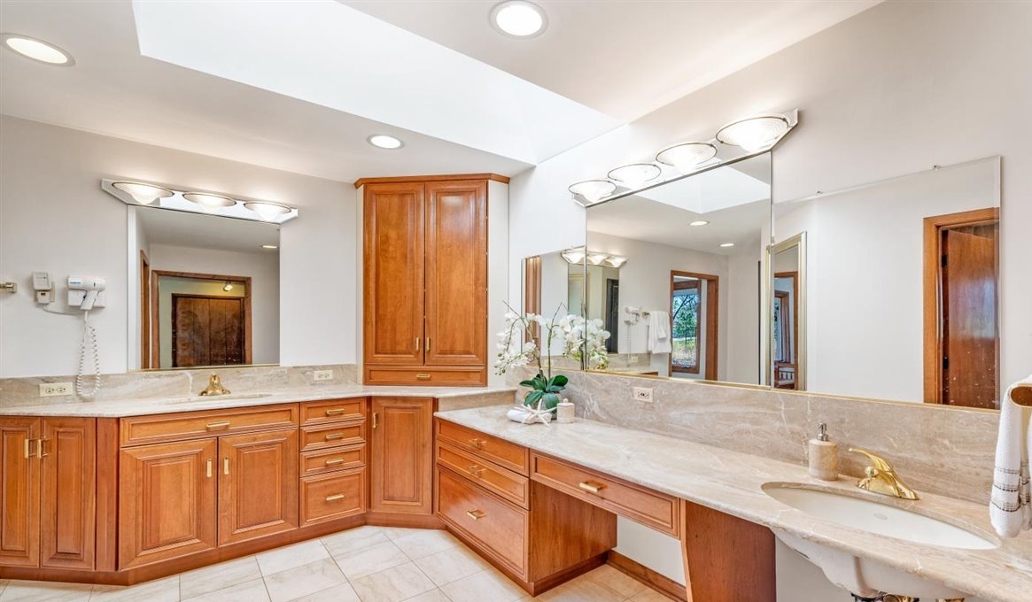1 Wood Creek Road Barrington, IL 60010 - Photo 22 of 40 a bathroom with a granite countertop double vanity sink and a large mirror