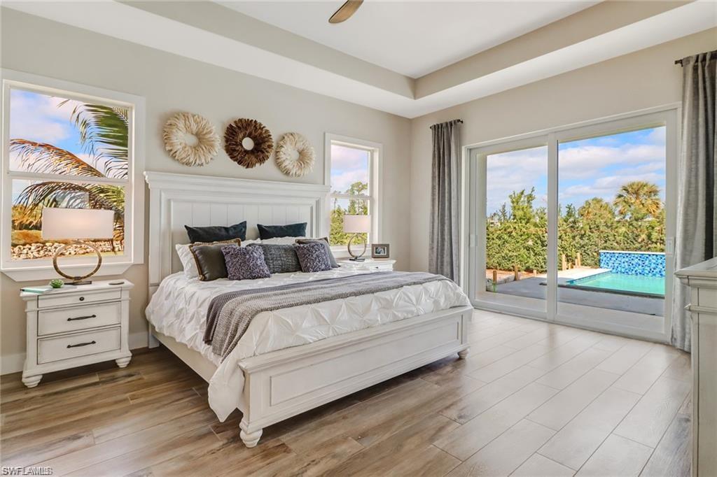 147 Cambria Lane Naples, FL 34112 - Photo 1 of 3 a bedroom with a bed and a large window