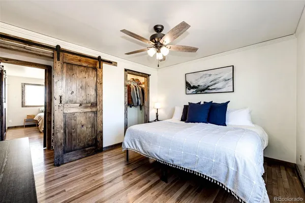 a bedroom with a large bed and a chandelier