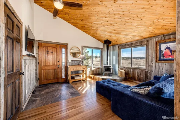 a living room with furniture fireplace and wooden floor