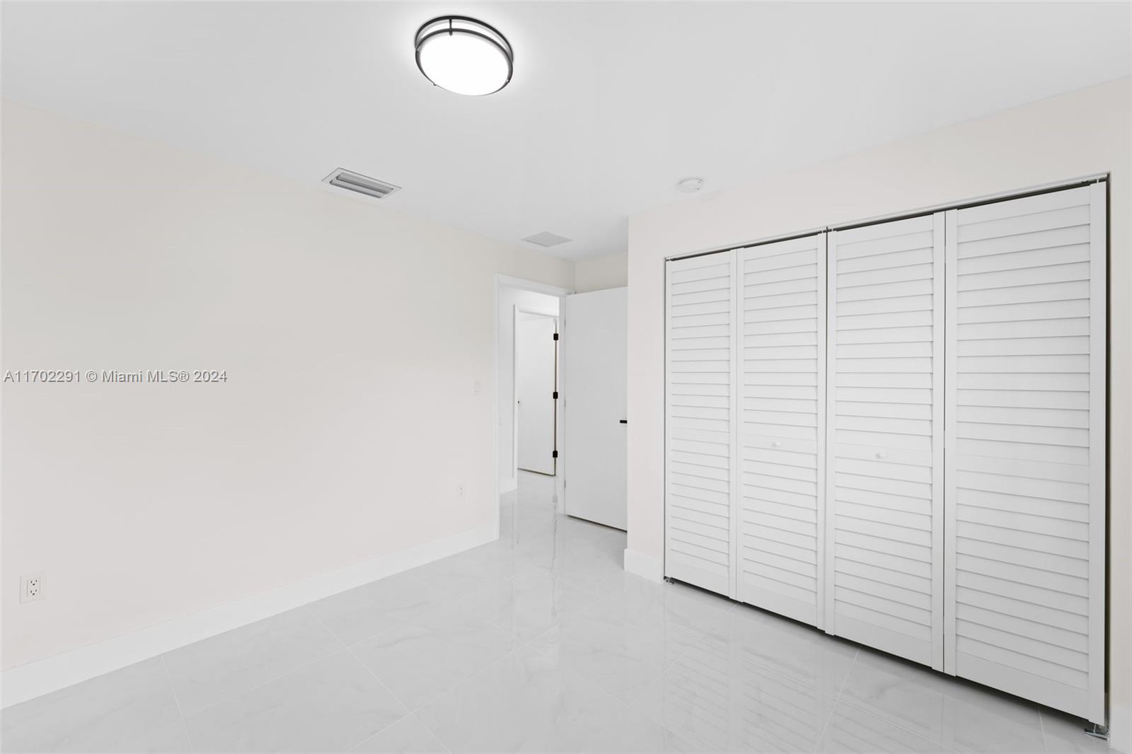 1999 Northwest 46th Street Miami, FL 33142 - Photo 13 of 22 a view of a room with white walls