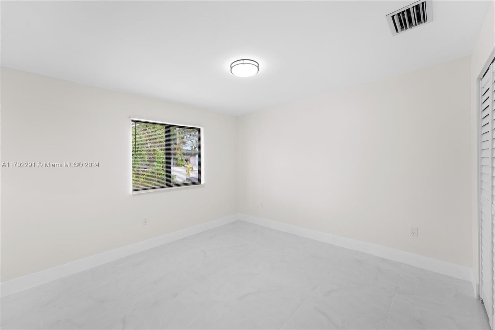 1999 Northwest 46th Street Miami, FL 33142 - Photo 14 of 22 an empty room with windows
