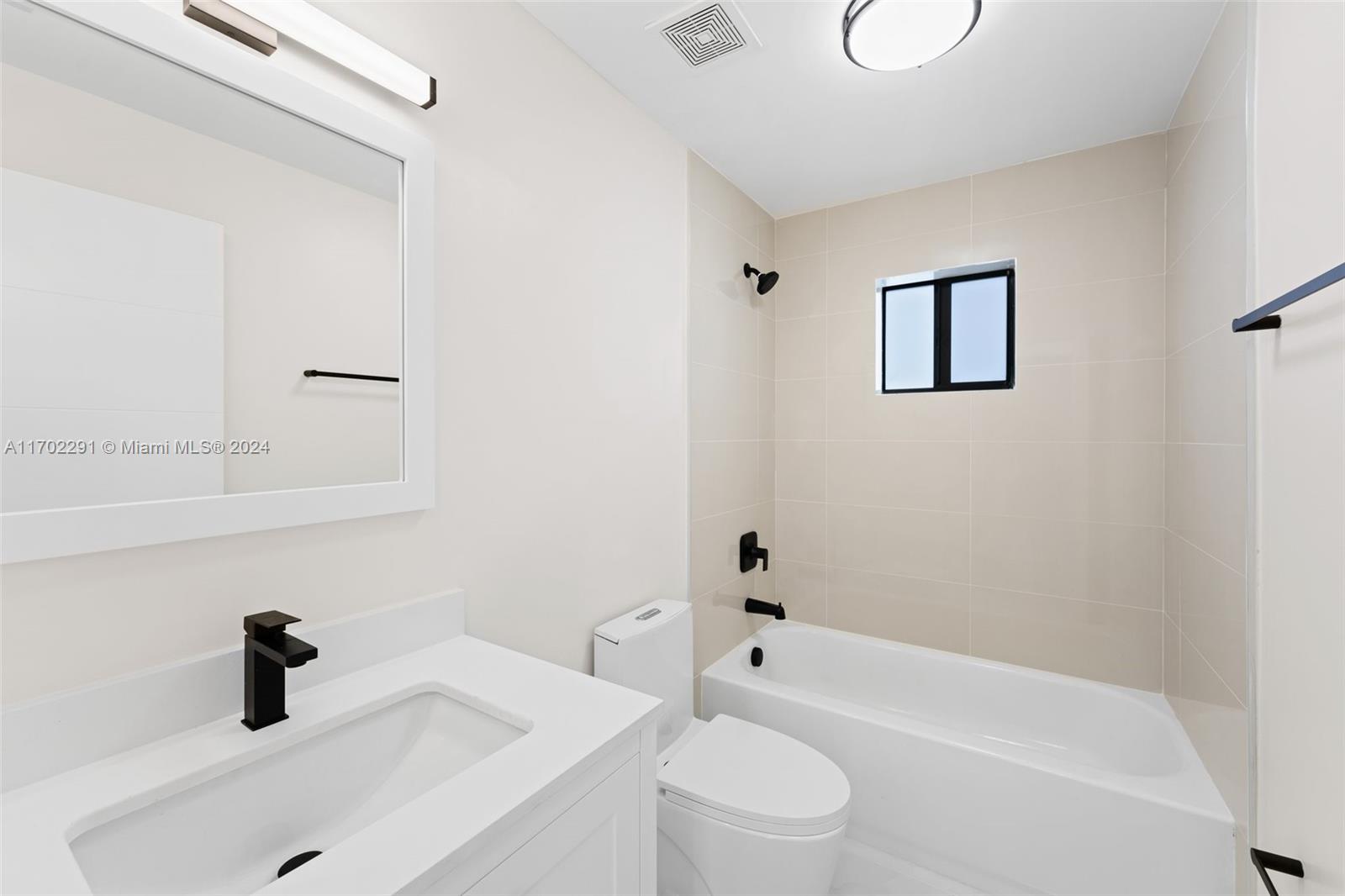1999 Northwest 46th Street Miami, FL 33142 - Photo 17 of 22 a bathroom with a sink a toilet and a bathtub
