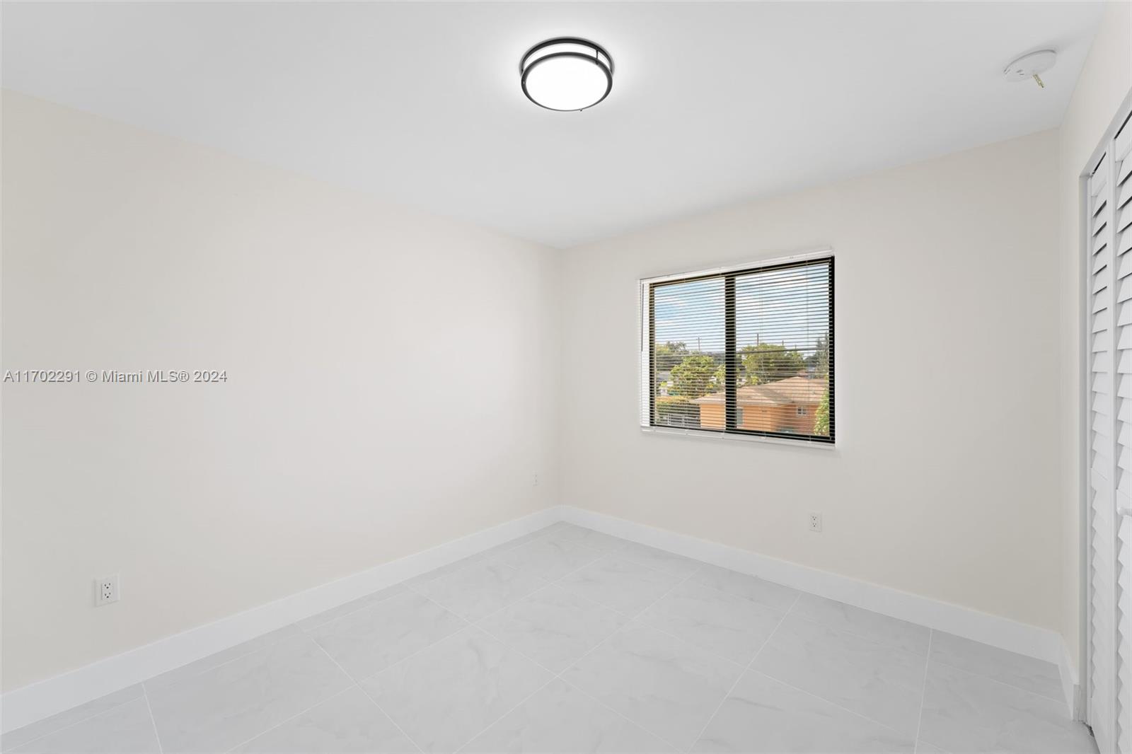 1999 Northwest 46th Street Miami, FL 33142 - Photo 18 of 22 an empty room with a window