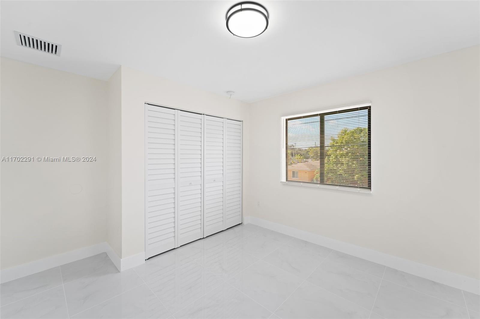 1999 Northwest 46th Street Miami, FL 33142 - Photo 19 of 22 an empty room with windows