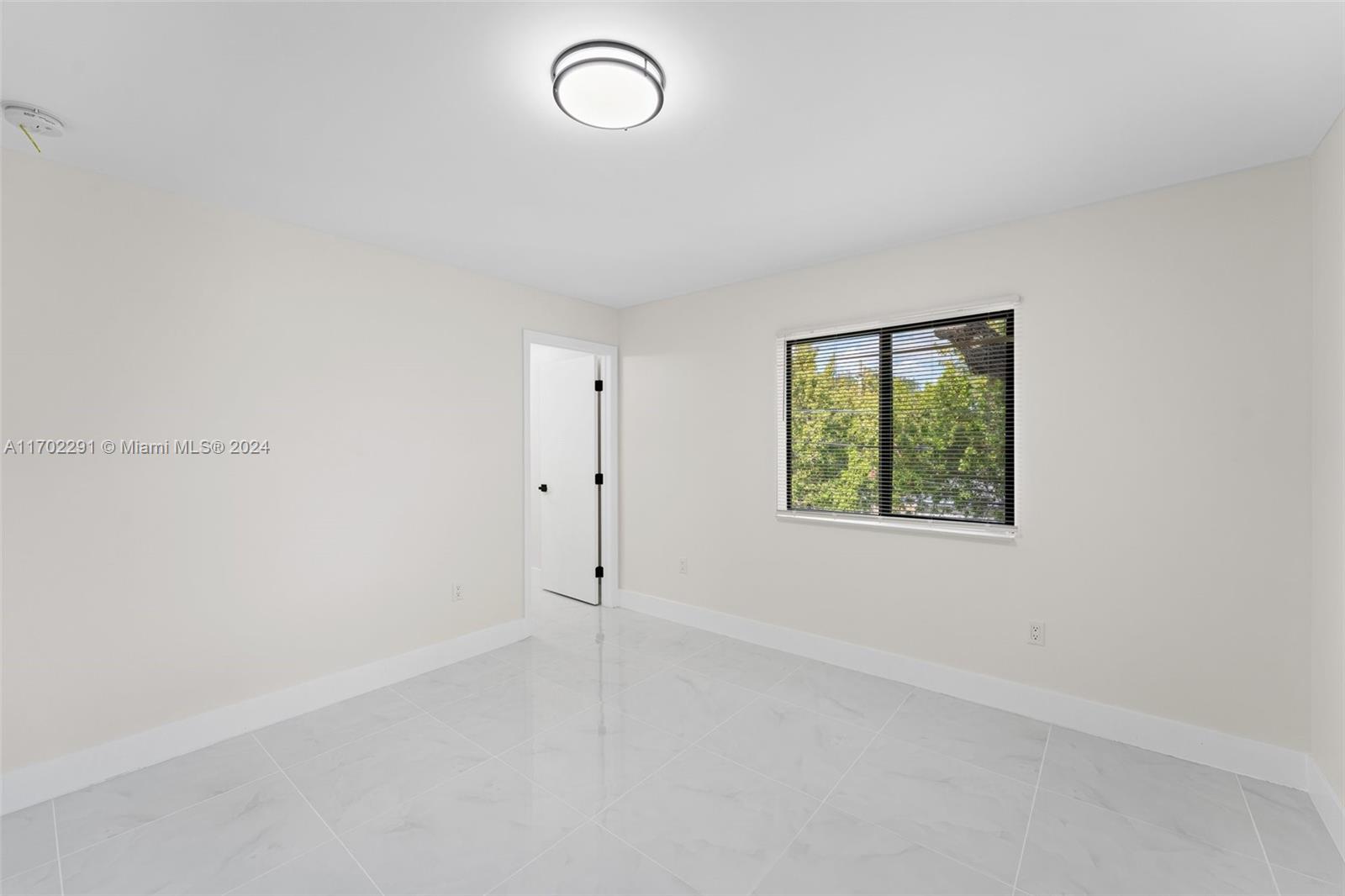 1999 Northwest 46th Street Miami, FL 33142 - Photo 22 of 22 an empty room with a window