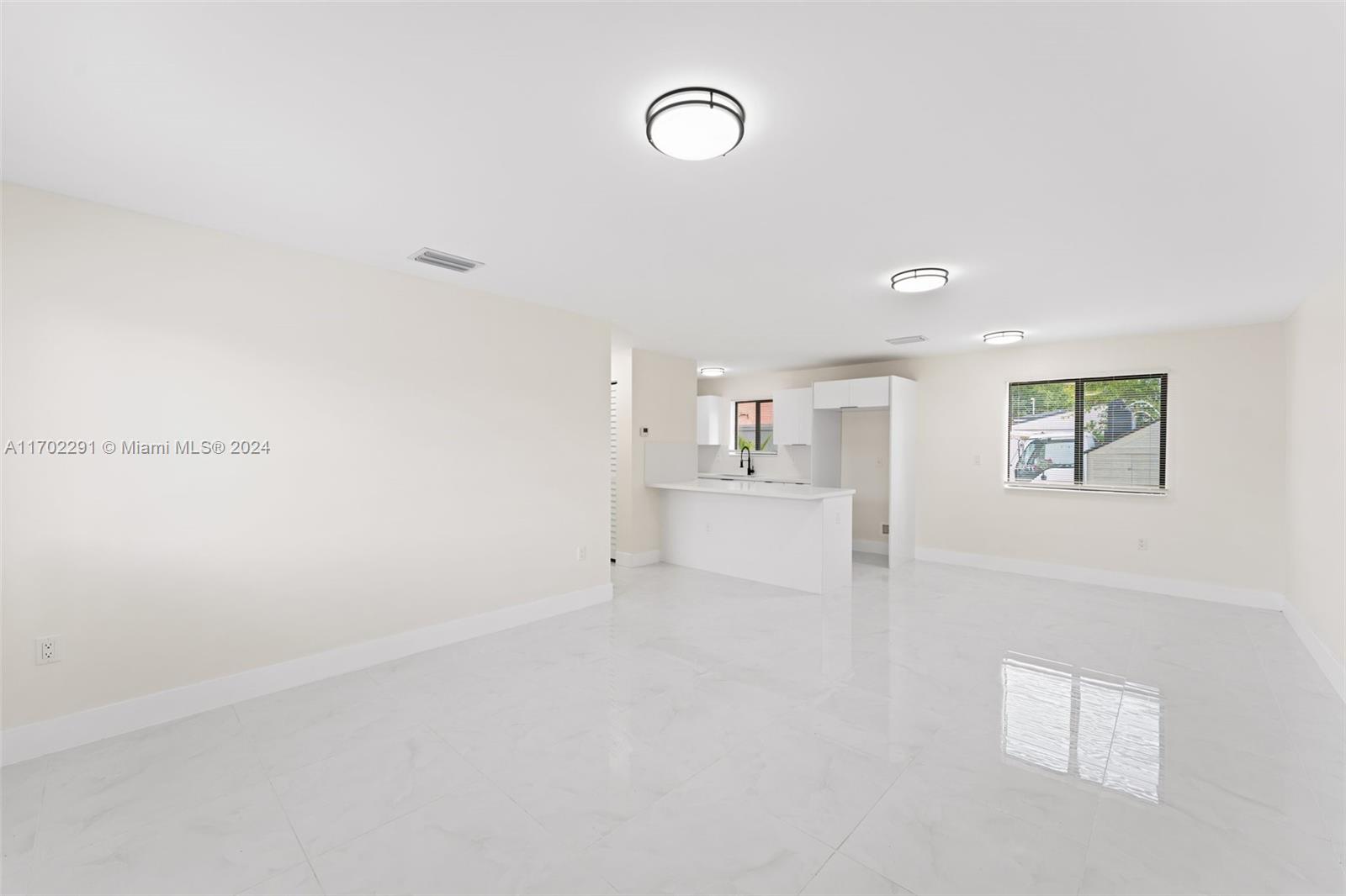 1999 Northwest 46th Street Miami, FL 33142 - Photo 4 of 22 a view of a kitchen with white cabinets