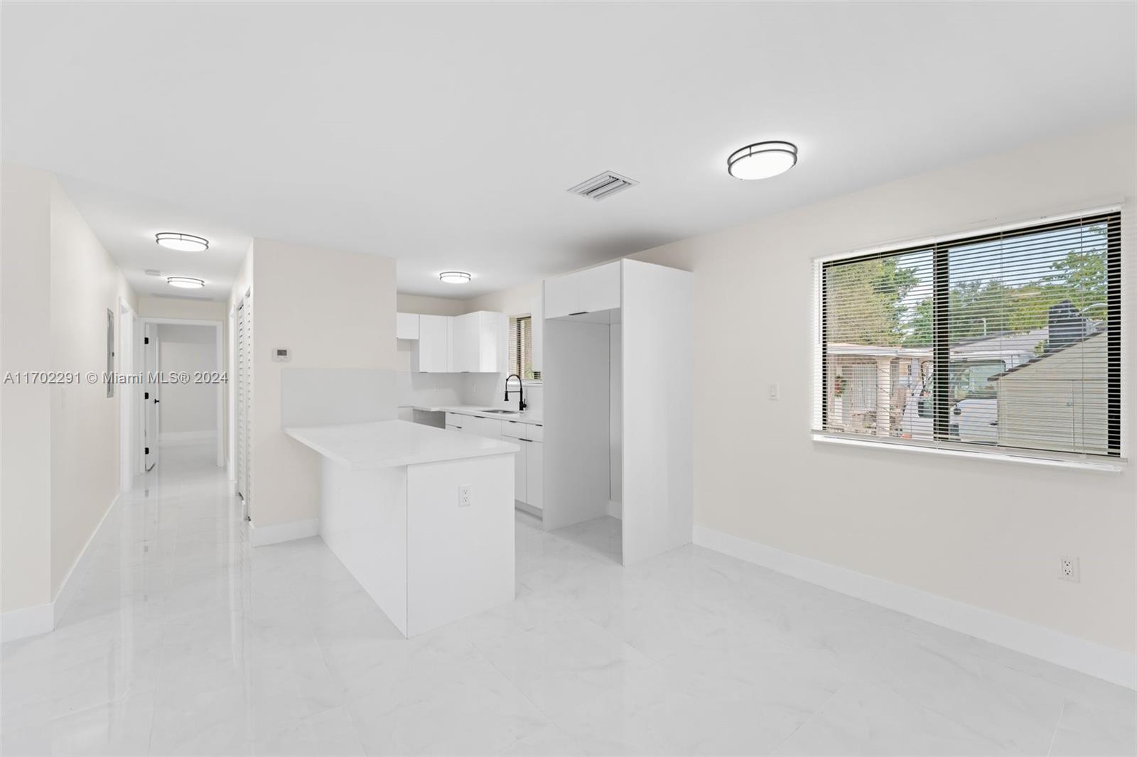 1999 Northwest 46th Street Miami, FL 33142 - Photo 9 of 22 a large white kitchen with white cabinets