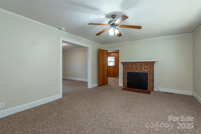 a view of an empty room with a fireplace