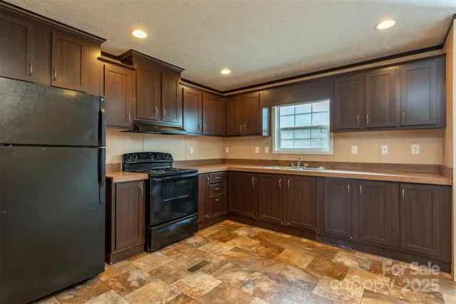 a kitchen with a refrigerator and a sink