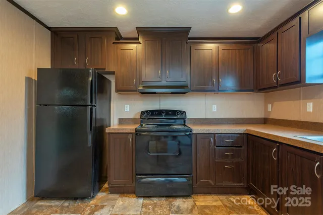 a kitchen with a refrigerator stove and cabinets