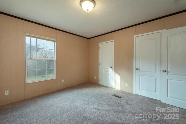 an empty room with windows and closet