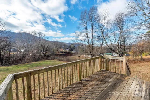 a balcony with wooden floor and fence