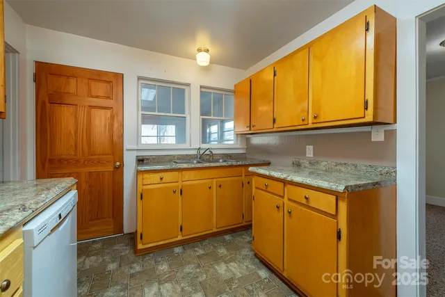a kitchen with granite countertop cabinets stainless steel appliances granite counter tops and a window