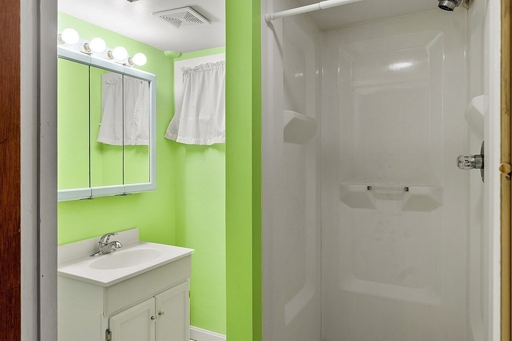 11 Mc Intosh Road Chelmsford, MA 01824 - Photo 15 of 20 a bathroom with a sink and a mirror