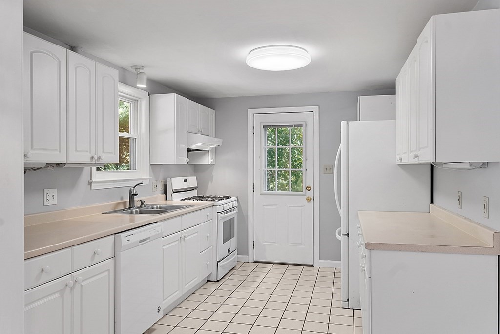 11 Mc Intosh Road Chelmsford, MA 01824 - Photo 3 of 20 a kitchen with a sink cabinets and window