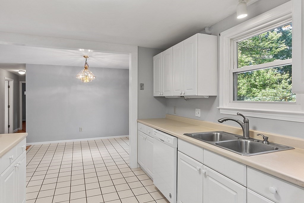 11 Mc Intosh Road Chelmsford, MA 01824 - Photo 4 of 20 a kitchen with a sink cabinets and window