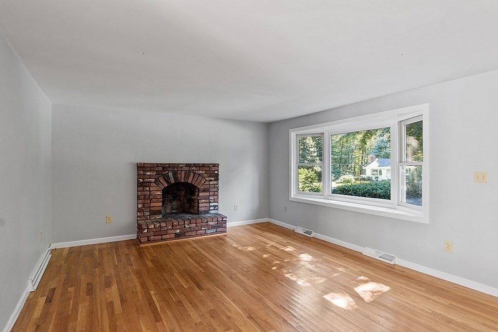 11 Mc Intosh Road Chelmsford, MA 01824 - Photo 7 of 20 wooden floor in an empty room with a window