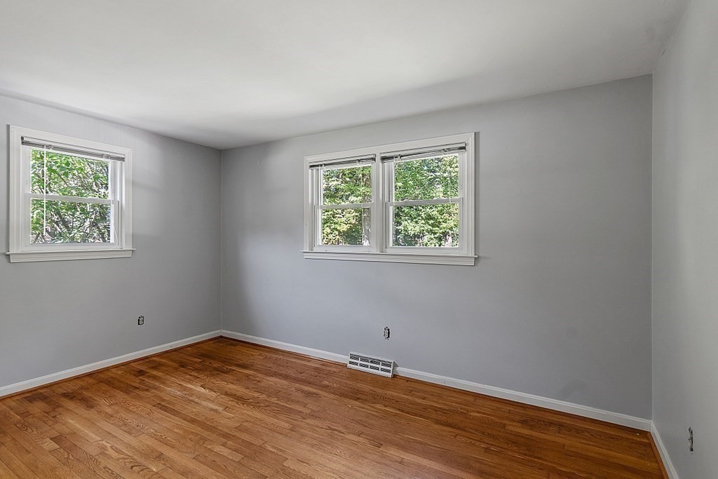 11 Mc Intosh Road Chelmsford, MA 01824 - Photo 9 of 20 a view of empty room with wooden floor and fan