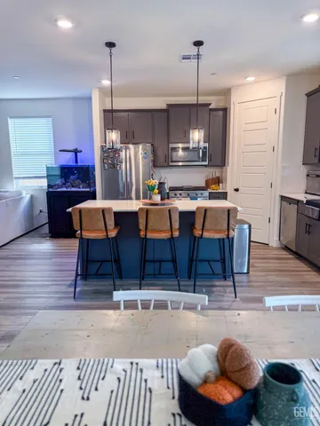 a living room with lots of furniture and kitchen view