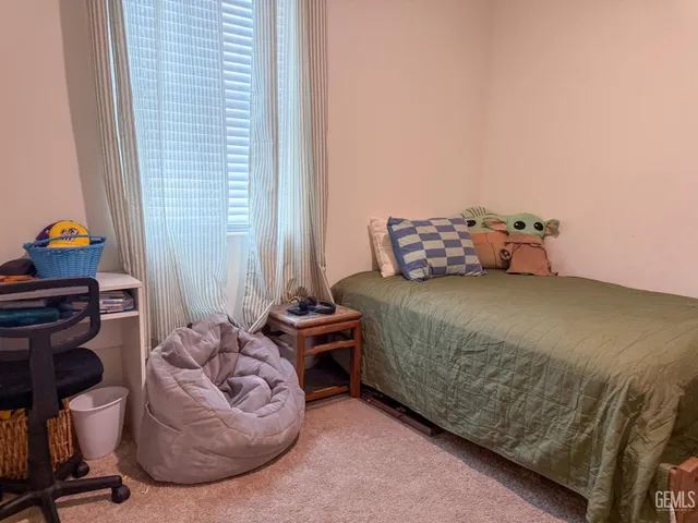 a bedroom with a bed and a chair