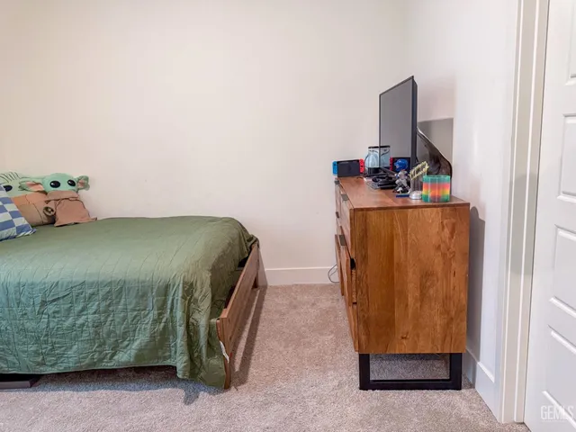 a bedroom with a bed and a potted plant