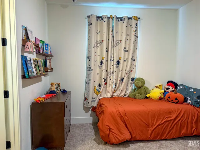 a bedroom with a bed and a book shelf