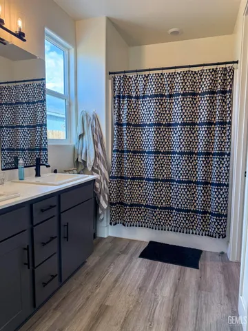 a view of a room with wooden floor