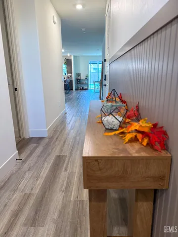 a room with stainless steel appliances wooden floor and chair