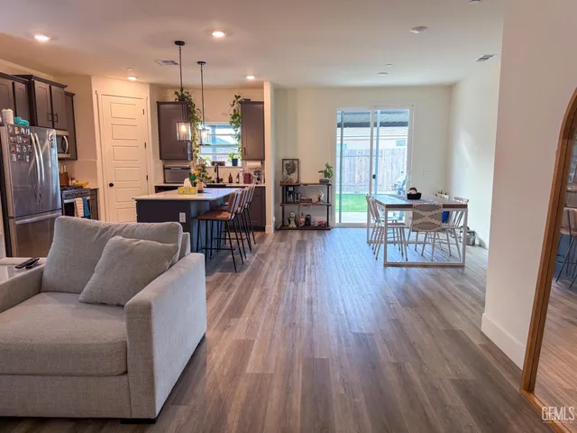 a living room with furniture and kitchen view