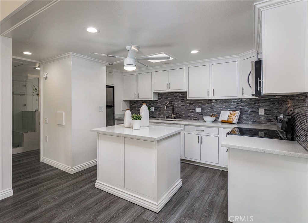 13280 St Andrews Drive, Unit 256A Seal Beach, CA 90740 - Photo 4 of 21 a kitchen with stainless steel appliances granite countertop a sink stove and refrigerator