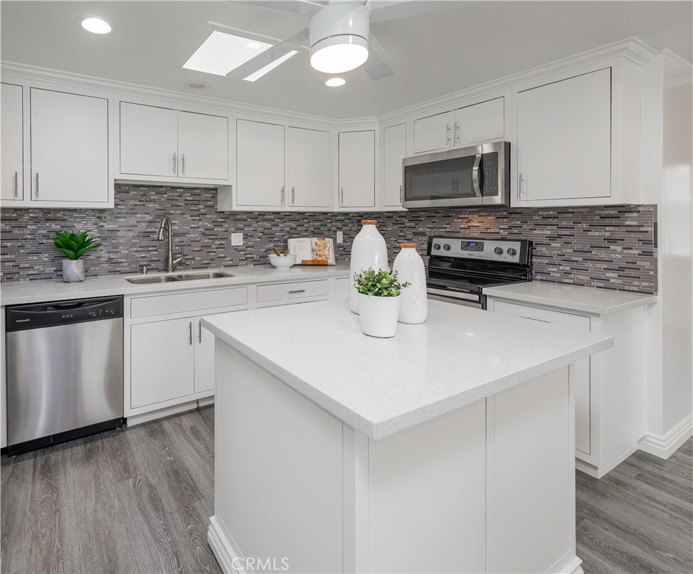 13280 St Andrews Drive, Unit 256A Seal Beach, CA 90740 - Photo 5 of 21 a kitchen with sink a microwave and cabinets